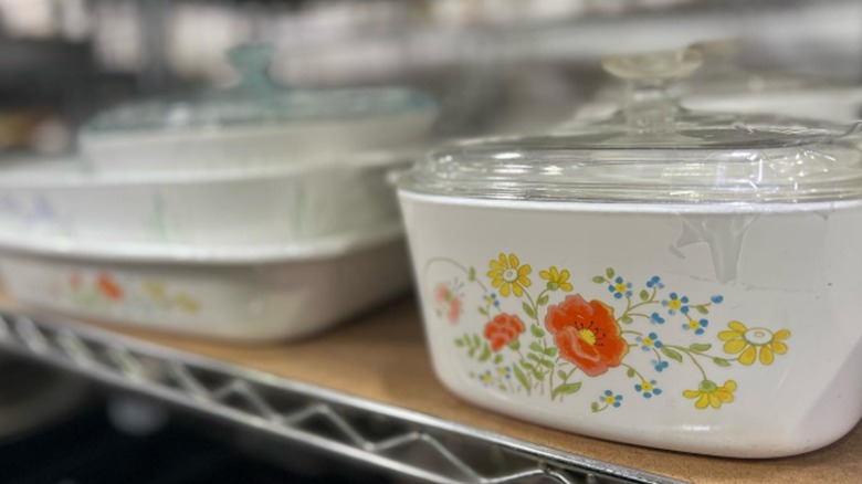 A Corning Ware casserole dish with the Wildflower pattern on a store shelf.