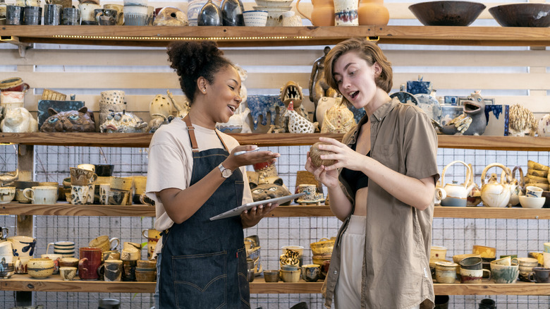 person speaking with store employee about home decor