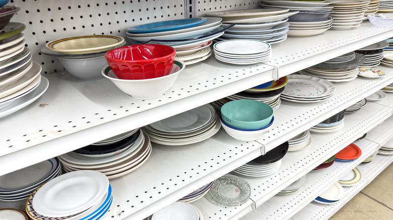 Thrift store with shelves full of dishes.