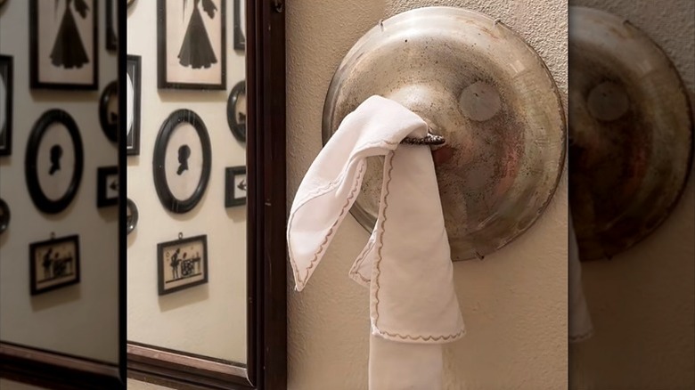 Towel hanging on the handle of an old plate cover
