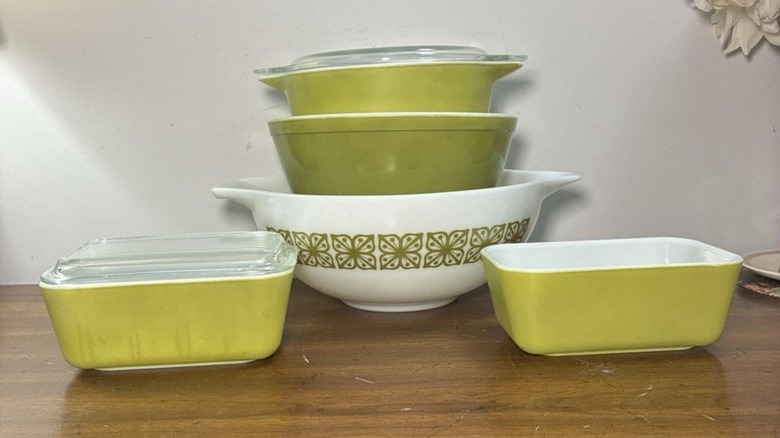 A collection of Pyrex Verde refrigerator dishes and mixing bowls.