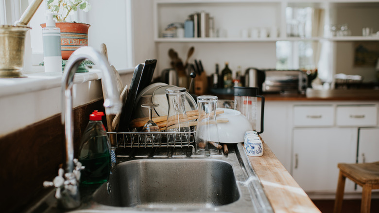 Clean dishes on a drying rack by the sink