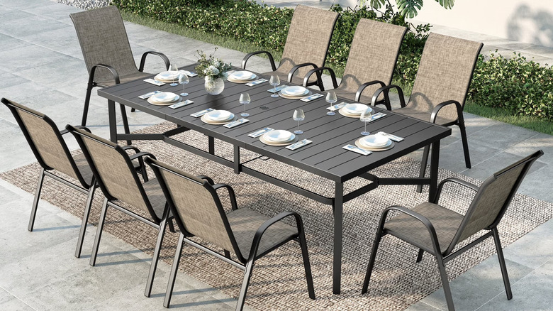 A spacious outdoor dining set sits on a neutral patio