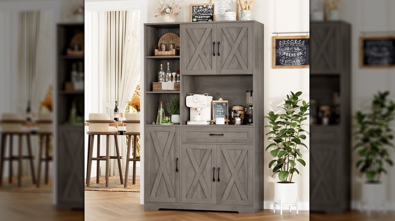 A gray Hiphuta Freestanding Hutch sits next to a potted plant in a neutral kitchen