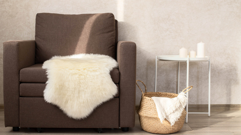 Sheepskin rugs tossed over a chair seat and in a basket