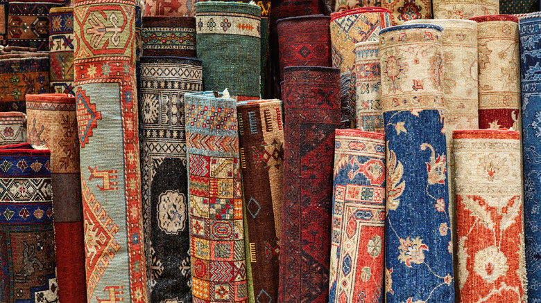 Colorful rolled up vintage rugs grouped together
