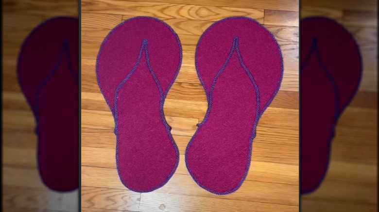 A cat scratcher shaped like flip-flops made from carpet tiles