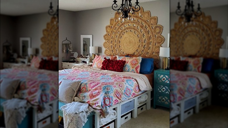 A round boho rug hung over a bed as a headboard