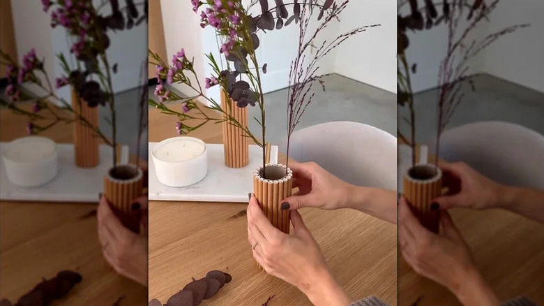 Cardboard tube turned into chic wood-like vase with drinking straws for artificial foliage decor