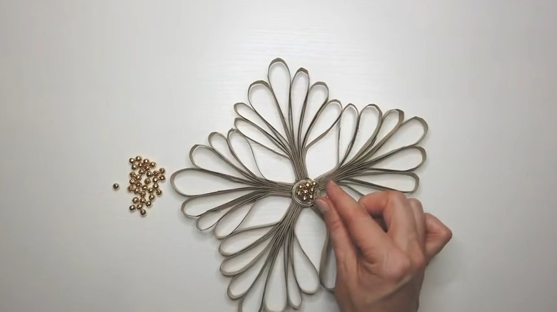 Paper towel cardboard tubes sliced into thins trips for DIY wall art with gold beads