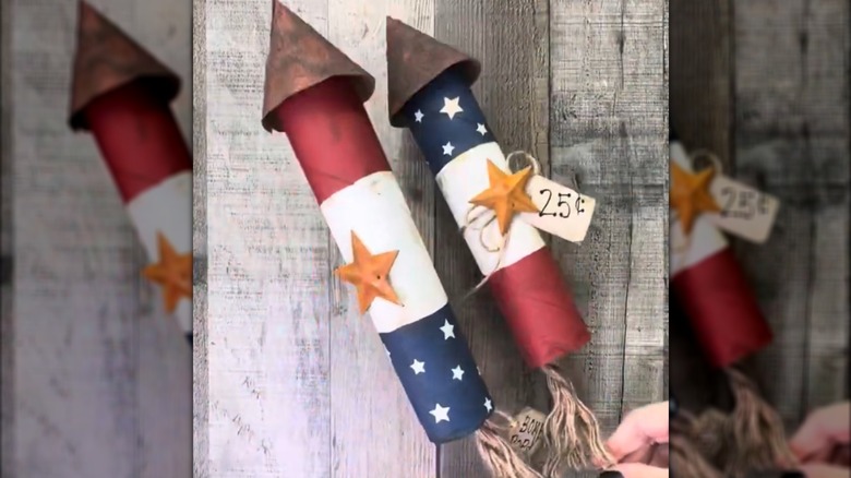 DIY cardboard tube paper rockets for Fourth of July centerpiece over wood background