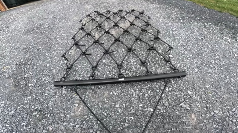 A chain harrow dragging over gravel