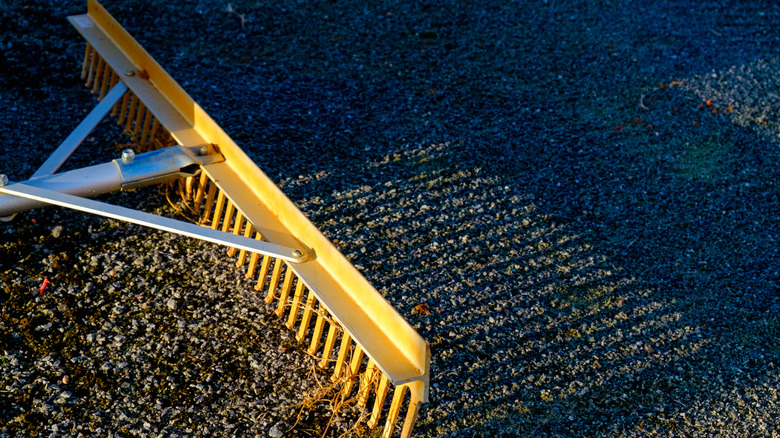 A rake passing over gravel