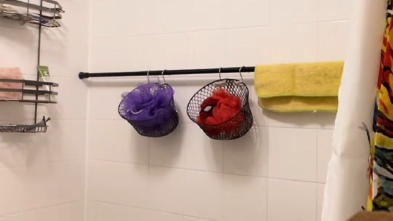 Curtain rod hung in bathtub to organize shower essentials