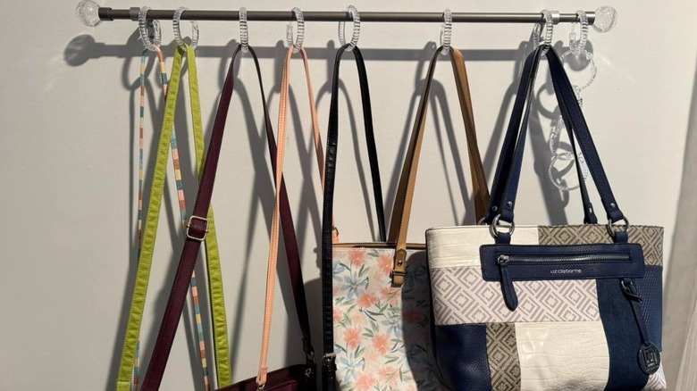 Purse collection hung on curtain rod