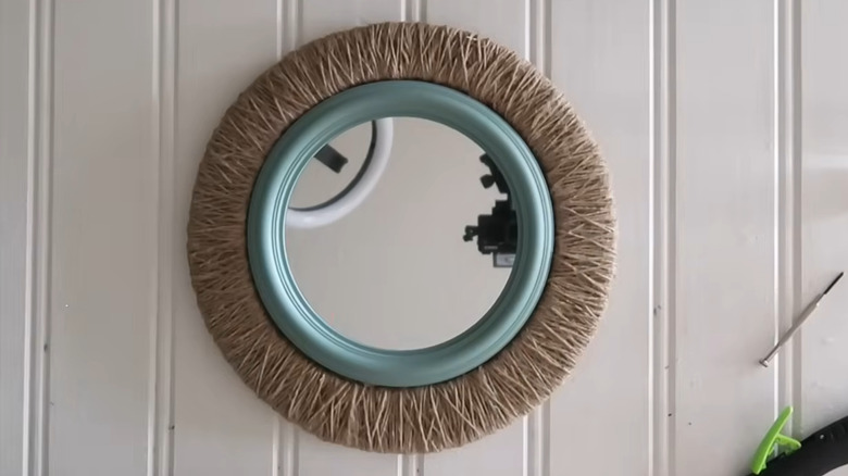 Wall mirror made with a pizza pan to create the frame