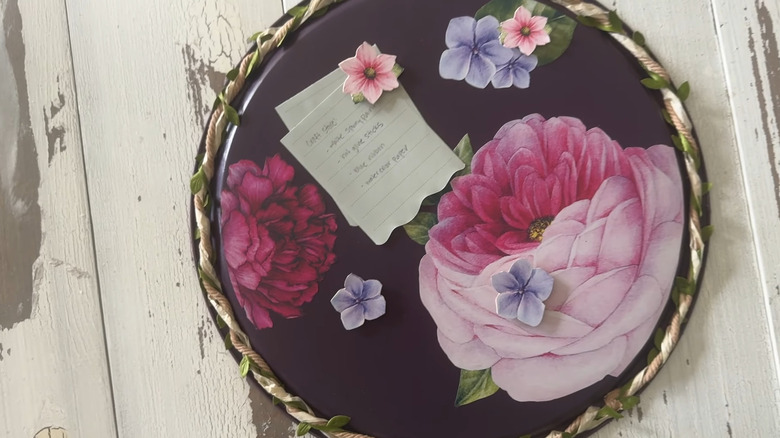 Magnetic memo board with a floral design hanging on a wall