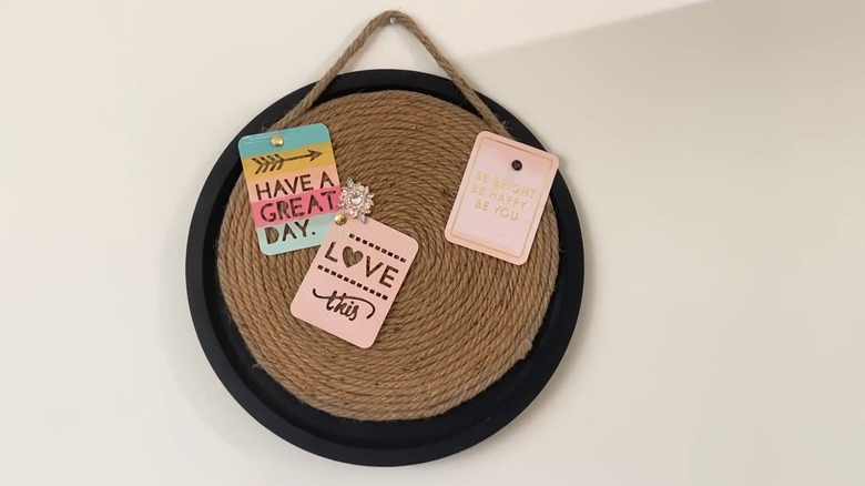 Pizza pan push pin board hanging on a wall
