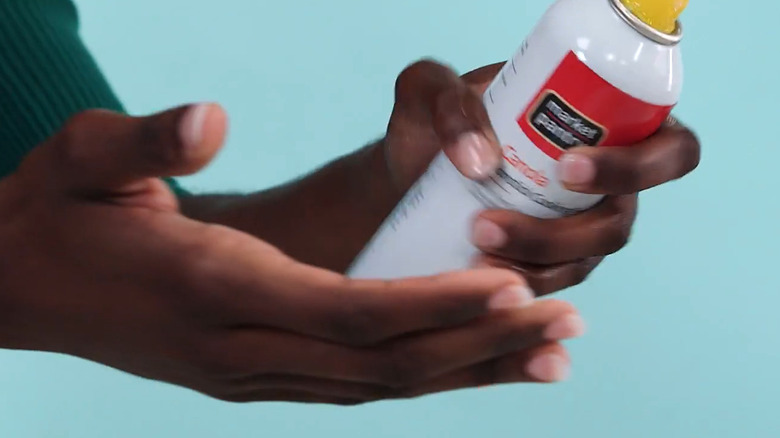 Applying cooking spray to hands