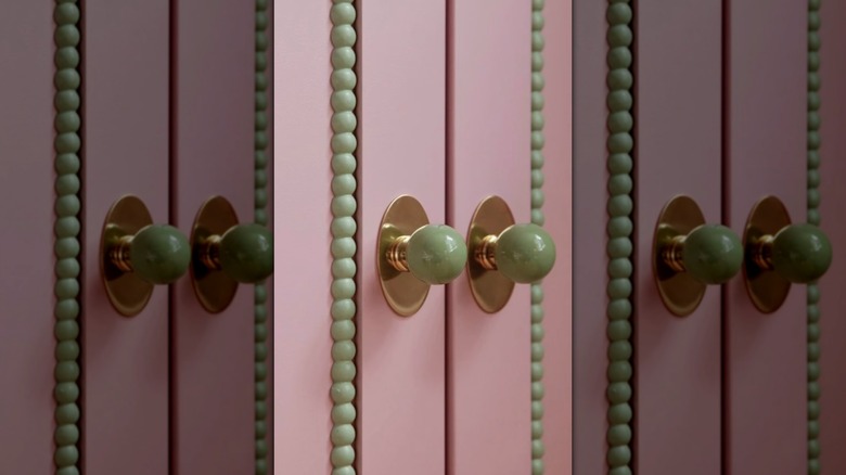 Beaded trim along a pink cabinet