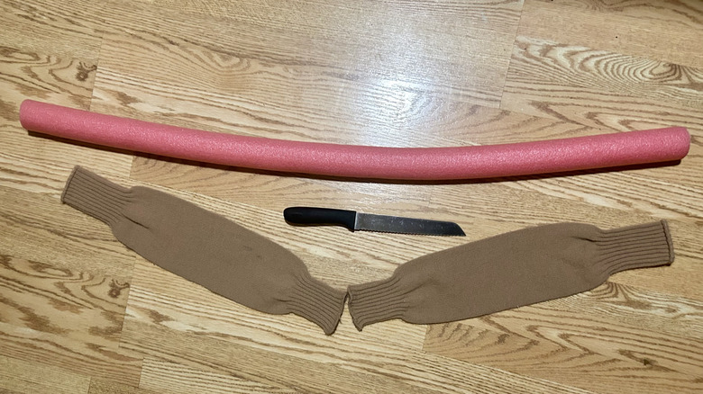 A pink pool noodle, a bread knife, and two tan leg warmers