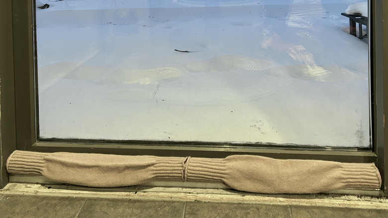 A draft stopper made with a pool noodle and leg warmer