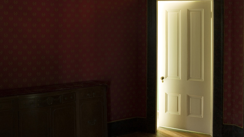 partially open white interior french doors