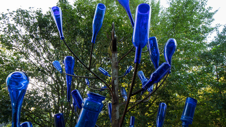 Bottle tree with only cobalt blue bottles on it