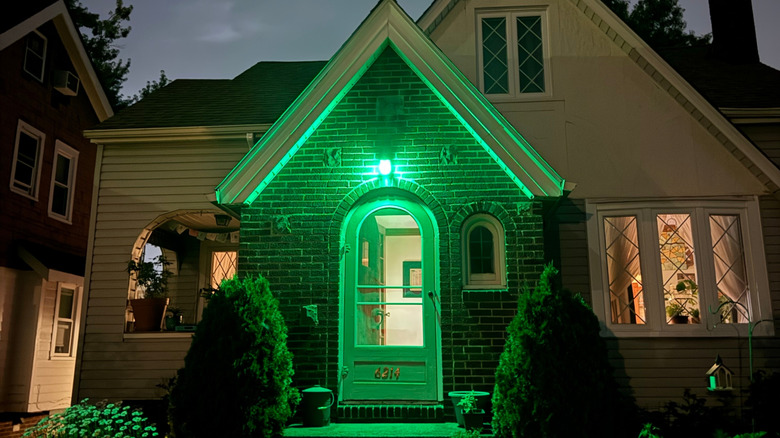 A home with a large green light over the front porch
