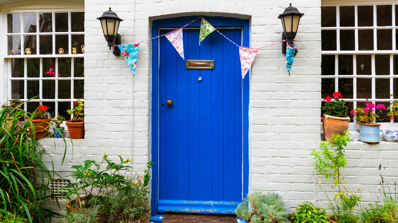 Blue front door on white painted brick house
