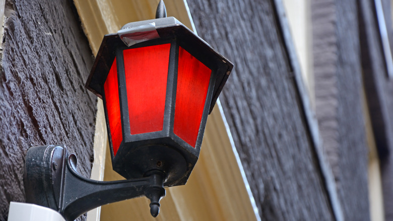 A red lamp mounted to a home's exterior