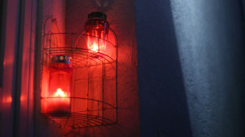 Red lights burning on the side of a house