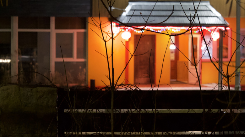 Orange glow of porch light seen from afar