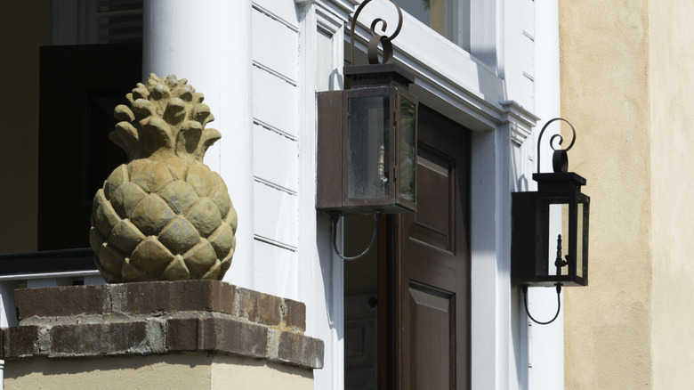 A pineapple statue on a front porch