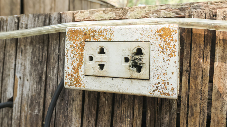 An outdoor electrical socket with a burnt outlet