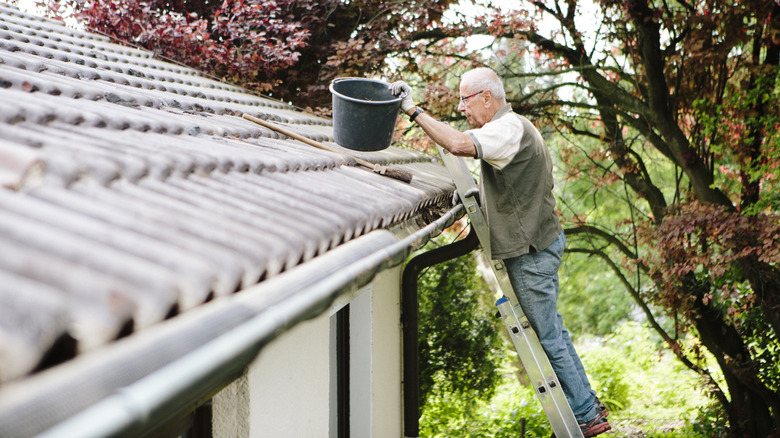 Old man getting ready to clean gutters