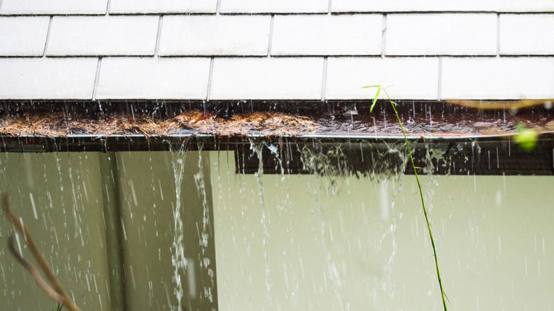 clogged gutter overflowing with rain