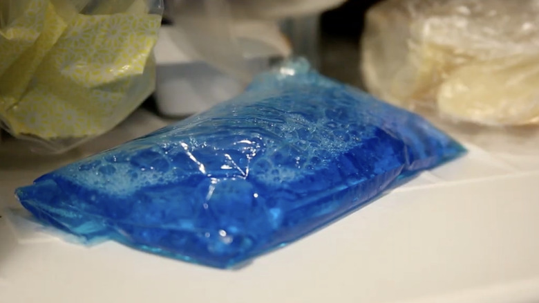 A plastic bag filled with dish soap inside a freezer