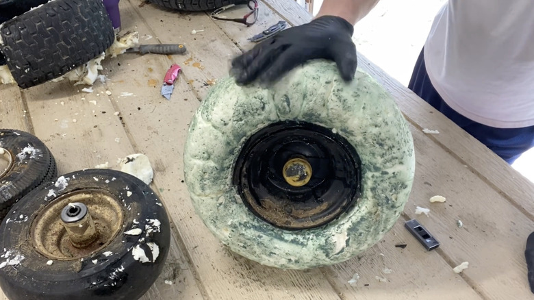 YouTuber showing what happens to the inside of a mower tire when filled with foam