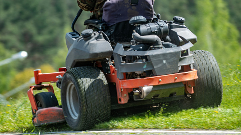 Man riding zero turn lawn mower