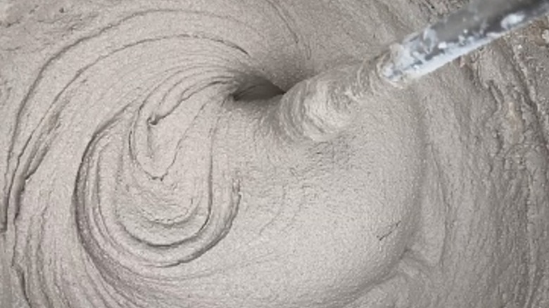 Mixing paddle inside a bucket of concrete