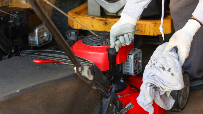 Checking the oil in a small lawn mower