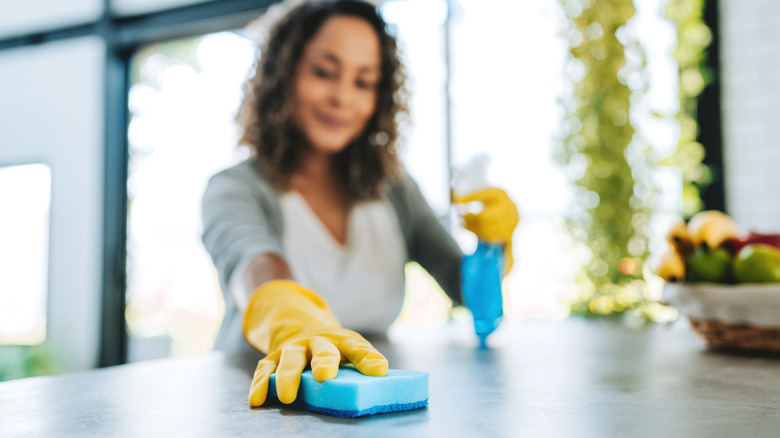 wiping counter with disinfectant