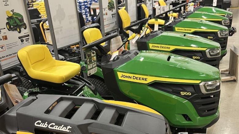 Row of John Deere riding mowers in a store