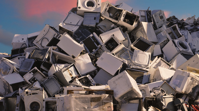 A pile of old electrical appliances at a landfill or scrap yard