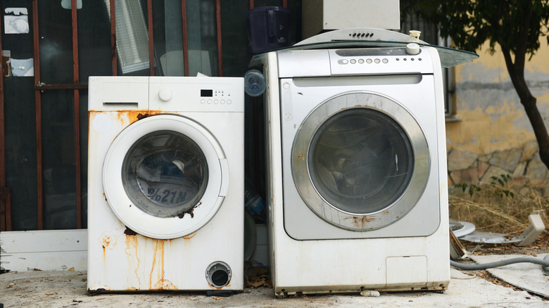 Old, rusty washing machines curbside