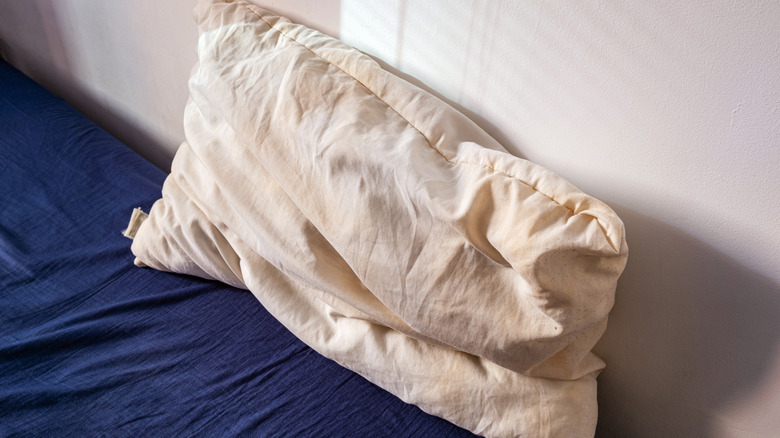Old pillow on bed