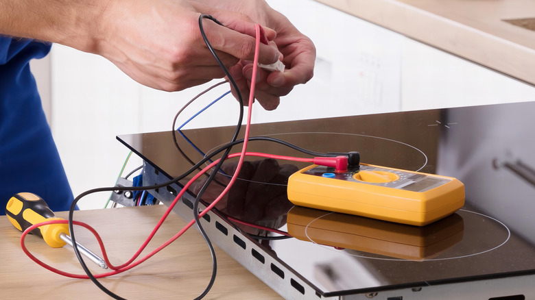 Electrician installing an electric induction cooktop