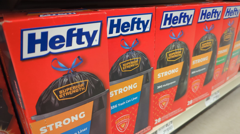 Boxes of Hefty Strong Garbage Bags sit on a Dollar Tree shelf