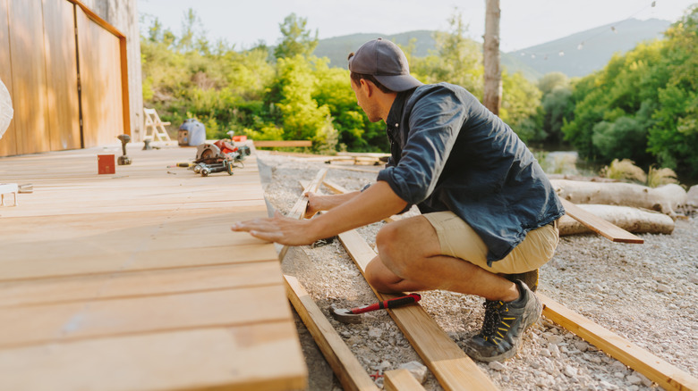 Man installing a wood deck